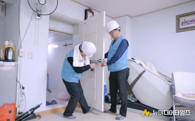 용산구 스피드 용반장들이 지역 소규모 복지시설을 방문해 고장난 문고리를 고쳐주고 있다.