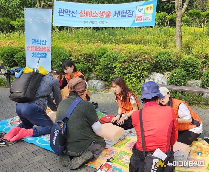 관악산공원 폭포쉼터에서 열린 관악산 심폐소생술 체험장에서 주민들이 심폐소생술 교육을 받고 있다